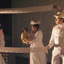 Photograph of Yerandy Basart (Caballero 3) and Fara Madrigal (Dama 1) in the theatrical production, Los zapaticos de rosa